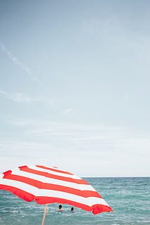 beach umbrella, people, background, Bay, Blue, Cloud, Coast, Holiday, Horizon, Ocean, Swimming, Tourism, Tourists, Tropical, Umbrella, View, beach, holidays, leisure, nature, red white, sea, seascape, selective focus, shore, summer, swimwear, travel, vacation, water, sky, horizon over water, red, striped, scenics - nature, day, beauty in nature, shade, tranquil scene, tranquility, flag, parasol, outdoors, no people, wind, 2K