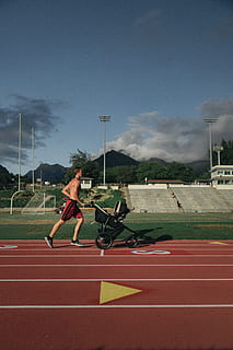 man, running, holding, stroller, sport, full length, sky, track and field, one person, real people, sports track, lifestyles, running track, nature, day, leisure activity, men, motion, sunlight, cloud - sky, determination, young adult, outdoors, effort, 5K, CC0, public domain, royalty free