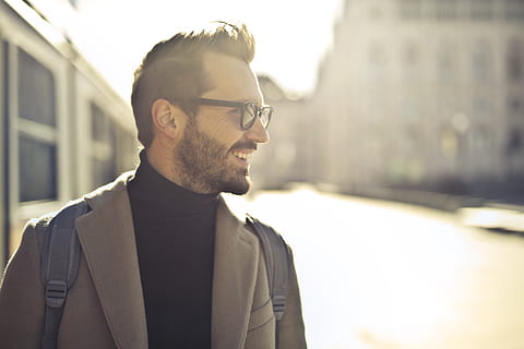 shallow, focus photography, man, wearing, eyeglasses, backlight, backpack, blur, blurred background, city, close-up, coat, contemporary, daylight, daytime, eyewear, facial expression, facial hair, fashion, fine-looking, formal, handsome, looking, outfit, person, photoshoot, smile, street, train, urban, wear, white, windows, one person, glasses, beard, architecture, portrait, headshot, young men, young adult, men, stubble, focus on foreground, sunlight, standing, building exterior, outdoors, lens flare, 5K, CC0, public domain, royalty free