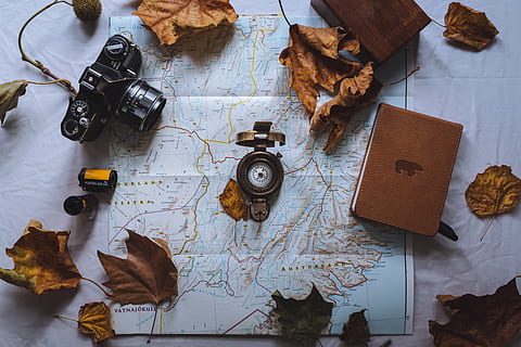 black, dslr camera, map, background, camera, close-up, compass, high angle view, table, equipment, still life, no people, indoors, directly above, world map, paper, communication, wood - material, guidance, metal, nature, brown, leaf, technology, publication, navigational compass, leaves, 8K, CC0, public domain, royalty free