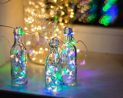 tiga, botol, lampu senar, Kyiv, ukraina, kaca, aksesoris, titisan, minum, minuman, perhiasan, bling, ornamen, penerangan, api, diterangi, dalam ruangan, tidak ada orang, dekorasi, bahan kaca, fokus pada latar depan, transparan, meja, wadah, malam, merapatkan, peralatan penerangan, multi-warna, bersinar, masih hidup, hari Natal, fenomena cahaya - alami, berkilau, liburan, cahaya, 4K, CC0, domain publik, bebas royalti