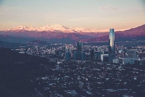 building, structure, sky, infrastructure, window, establishment, hotel, city, urban, architecture, art, glass, roof, clouds, mountains, sunlight, building exterior, built structure, mountain, cityscape, nature, residential district, no people, cloud - sky, high angle view, sunset, travel destinations, outdoors, mountain range, day, skyscraper, office building exterior, pollution, 5K, CC0, public domain, royalty free