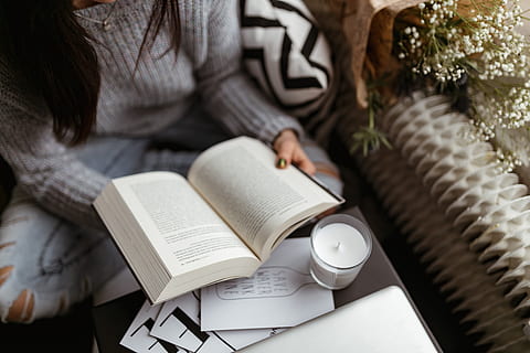 woman, sweater, reads, book, reading, reader, opened book, girl, female, lifestyle, relax, time, candle, pullover, jumper, one person, publication, adult, women, midsection, indoors, holding, drink, cup, coffee cup, coffee - drink, real people, lifestyles, casual clothing, mug, refreshment, sitting, hand, 4K, CC0, public domain, royalty free