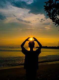 silhouette photo, person, raising, hands, backlit, beach, clouds, dawn, environment, nature, ocean, oceanshore, oceanside, scenery, scenic, sea, seascape, seashore, seaside, sky, sun glare, sunrise, sunset, water, human arm, real people, beauty in nature, one person, scenics - nature, standing, silhouette, cloud - sky, arms raised, orange color, lifestyles, land, leisure activity, limb, sun, outdoors, 4K, CC0, public domain, royalty free