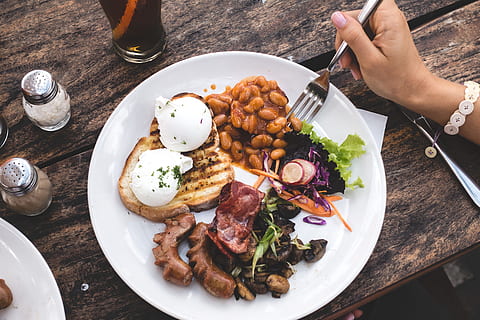 eating, high, protein brunch, poached eggs, beans, bacon, breakfast, brunch, café, coffeeshop, eggs, hands, healthy, top view, wood, food and drink, food, plate, human hand, table, ready-to-eat, eating utensil, freshness, hand, kitchen utensil, high angle view, meat, human body part, fork, healthy eating, meal, indoors, household equipment, vegetable, directly above, glass, table knife, dinner, garnish, temptation, 5K