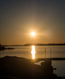 sunset, ocean, archipelago, dck, summer, juhannus, midsummer, horizon, warm, yellow, glow, peaceful, water, sky, scenics - nature, reflection, beauty in nature, tranquility, silhouette, tranquil scene, sun, sunlight, sea, nature, idyllic, non-urban scene, beach, orange color, outdoors, no people, bright, 4K, CC0, public domain, royalty free