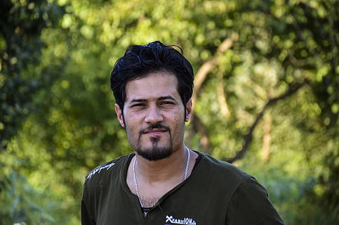 model, man, young, guy, people, male, adult, person, portrait, fashion, attractive, handsome, body, expression, face, human, cool, trendy, lifestyle, love, front view, one person, headshot, tree, looking at camera, plant, leisure activity, smiling, lifestyles, casual clothing, beard, real people, young adult, standing, focus on foreground, day, facial hair, young men, outdoors, 4K, CC0, public domain, royalty free