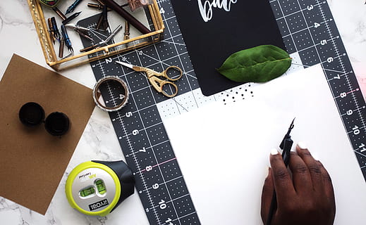 ruler, scissors, compass, design, art, leaves, calligraphy, paper, sheets, hand, human hand, high angle view, human body part, one person, pen, directly above, indoors, table, creativity, leaf, plant part, pencil, wellbeing, book, art and craft, healthy eating, publication, finger, note pad, 4K, CC0, public domain, royalty free
