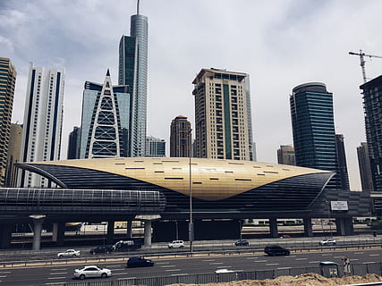 building, structure, infrastructure, window, establishment, hotel, city, urban, architecture, art, glass, roof, sky, crane, vehicles, cars, road, lane, building exterior, built structure, office building exterior, tall - high, skyscraper, modern, day, mode of transportation, transportation, office, tower, cloud - sky, nature, outdoors, no people, motor vehicle, cityscape, financial district, 2K, CC0, public domain, royalty free