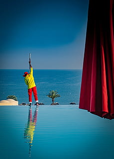 man, standing, beside, pool, beach, cleaner, infinity pool, Infinity pool cleaner, ocean, outdoors, person, reflection, resort, sea, travel, vacation, water, working, blue, sky, horizon over water, horizon, one person, rear view, nature, men, human arm, real people, beauty in nature, scenics - nature, day, arms raised, limb, human limb, 5K, CC0, public domain, royalty free