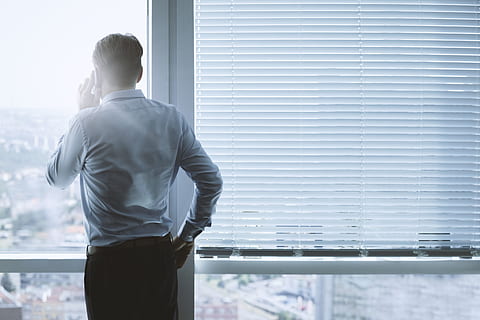 back, view portrait, businessman, talking, phone, office, rear view, one person, men, standing, three quarter length, window, business person, adult, business, copy space, males, corporate business, indoors, well-dressed, day, looking through window, businesswear, formal businesswear, contemplation, 5K, CC0, public domain, royalty free
