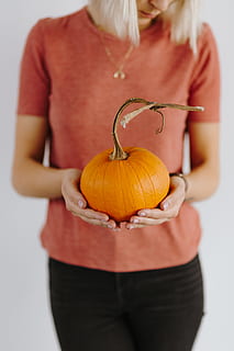 women, hands, sweater, holding, pumpkin, female, person, yellow, autumn, fall, orange, vegetable, halloween, midsection, food and drink, food, one person, front view, studio shot, adult, orange color, indoors, casual clothing, celebration, standing, females, blond hair, jack o' lantern, 4K