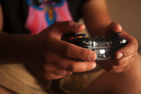 person, holding, black, game controller, blurred background, control, electronics, hands, indoors, man, portable, technology, wireless, human hand, hand, human body part, one person, close-up, midsection, adult, focus on foreground, arts culture and entertainment, men, occupation, front view, communication, wireless technology, finger, 2K, CC0, public domain, royalty free