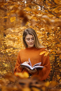woman, eyeglasses, orange, sweater, holding, book, autumn, reading, publication, one person, young adult, leaf, hair, looking down, activity, long hair, plant part, front view, plant, hairstyle, nature, tree, outdoors, change, beautiful woman, 5K, CC0, public domain, royalty free