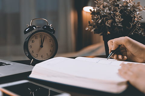work desk, retro, clock., midnight., time, clock, indoors, table, women, one person, hand, alarm clock, adult, selective focus, lifestyles, book, furniture, human body part, human hand, publication, close-up, desk, holding, clock face, 5K