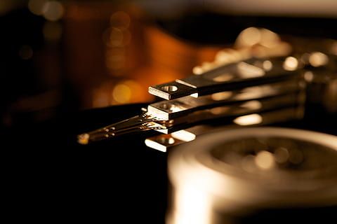 hard drive, electronics, computer, read head, hardware, storage medium, macro, close up, disk, datailaufnahme, mass storage, musical instrument, music, arts culture and entertainment, indoors, close-up, selective focus, no people, performance, skill, brass, brass instrument, musical equipment, single object, studio shot, metal, jazz music, trumpet, gold, 5K, CC0, public domain, royalty free
