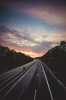 empty freeway, sky, cloud - sky, transportation, road, symbol, sign, the way forward, direction, marking, sunset, no people, road marking, tree, diminishing perspective, nature, highway, plant, car, mode of transportation, vanishing point, outdoors, dividing line, car point of view, multiple lane highway, 2K, CC0, public domain, royalty free