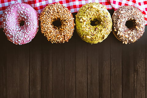 four, fantastic, american donuts, wooden, table, food, food and drink, baked, sweet food, sweet, no people, indulgence, dessert, donut, freshness, indoors, group of objects, temptation, variation, directly above, in a row, cake, snack, still life, muffin, 4K, CC0, public domain, royalty free