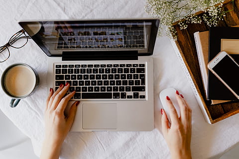 woman works, desk, laptop, cup, coffee, macbook, computer, work, study, home office, office, technology, cappucino, late, workspace, workplace, human hand, table, wireless technology, one person, hand, human body part, communication, adult, connection, high angle view, indoors, directly above, computer equipment, computer keyboard, keyboard, typing, using laptop, finger, 5K