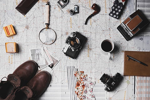 map, microscope, coffee, camera, pen, notebook, shoes, footwear, travel, outdoor, high angle view, indoors, directly above, table, still life, shoe, no people, flooring, technology, choice, photography themes, wood - material, communication, camera - photographic equipment, wireless technology, large group of objects, variation, publication, leather, container, personal accessory, 5K, CC0, public domain, royalty free