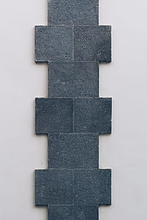 black cladding, grey, accessories, modern art, art, jeans, denim, clothing, pants, studio shot, no people, white background, indoors, large group of objects, pattern, still life, gray, close-up, shape, arrangement, full frame, order, repetition, creativity, high angle view, geometric shape, directly above, architecture, in a row, 5K, CC0, public domain, royalty free