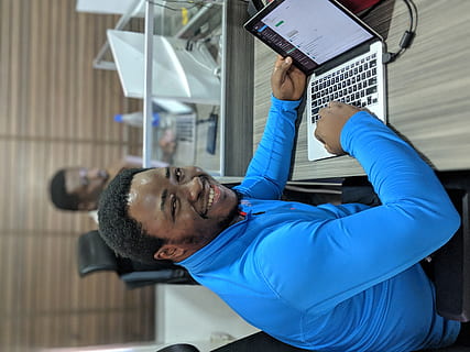 smiling, man, using, laptop computer, pc, computer, electronics, laptop, person, human, computer keyboard, hardware, keyboard, computer hardware, furniture, lcd screen, screen, display, monitor, lagos, 4a adewole kuku street, nigeria, table, desk, one person, real people, technology, holding, indoors, adult, wireless technology, men, lifestyles, males, connection, communication, looking, leisure activity, focus on foreground, young men, day, waist up, portrait, mature men, 4K, CC0, public domain, royalty free