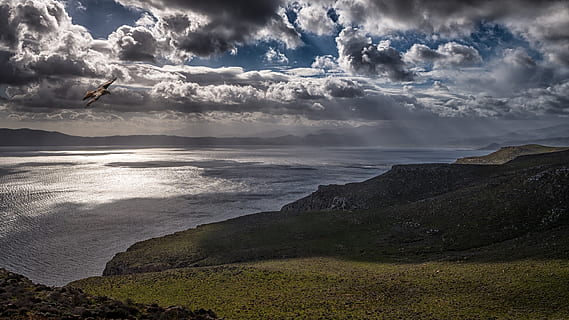 photo, ocean, cloudy, sky, beach, clouds, cloudy sky, daylight, environment, flight, flying, landscape, mountains, nature, scenery, scenic, sea, seascape, seashore, sunrays, water, cloud - sky, beauty in nature, scenics - nature, tranquil scene, land, tranquility, non-urban scene, horizon, rock, day, outdoors, horizon over water, rock - object, no people, 5K, CC0, public domain, royalty free