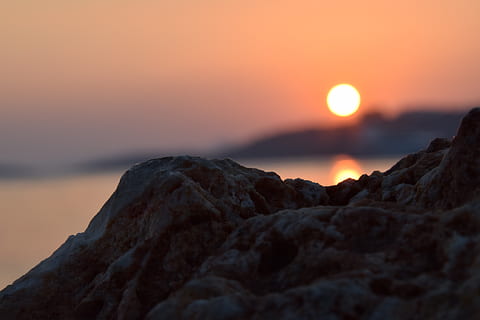 sunset, reflection, summer, color, solar, marine, sky, beauty in nature, rock, tranquility, orange color, tranquil scene, scenics - nature, rock - object, nature, solid, no people, mountain, non-urban scene, idyllic, sea, sun, land, silhouette, outdoors, mountain peak, 5K, CC0, public domain, royalty free