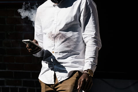 man smooking, texting photo, Men, Watch, Mens Fashion, Phones and Cases, Smoke, midsection, one person, holding, communication, standing, young adult, leisure activity, lifestyles, adult, young men, indoors, front view, social issues, clothing, wireless technology, activity, button down shirt, casual clothing, black background, 4K, CC0, public domain, royalty free