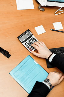persona, utilizzando, calcolatrice, Marrone, di legno, superficie, calcolatore, contemporaneo, dati, dispositivo, documento, formazione scolastica, fatti, tastiera, lavoro d'ufficio, statistica, lavoro, tavolo, mano umana, mano, tecnologia, vista dall'alto, parte del corpo umano, persone reali, in casa, uomini, tecnologia wireless, attività commerciale, persone, comunicazione, penna, computer, dispositivo di informazione portatile, scrivania, connessione, 5K, CC0, dominio pubblico, privo di copyright