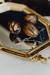 golden, easter eggs, gold, eggs, easter, painted, copper, black eggs, close-up, still life, selective focus, indoors, no people, high angle view, food and drink, food, table, focus on foreground, group of objects, wood - material, container, variation, metal, brown, reflection, freshness, choice, nut, 5K