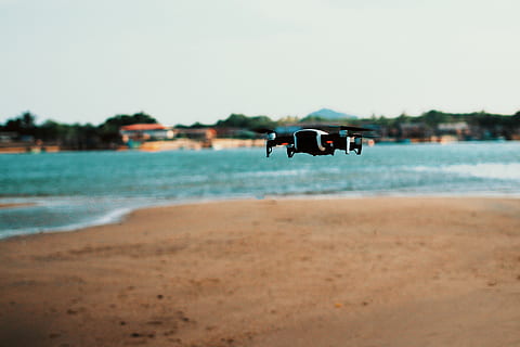black, quadcopter drone, flight, beach, camera, drone, macro, ocean, sand, sea, seashore, shore, land, water, sky, nature, focus on foreground, transportation, day, motion, incidental people, scenics - nature, mode of transportation, clear sky, outdoors, tree, travel, 4K, CC0, public domain, royalty free