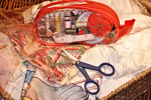 sewing, needlework, craft, needle, scissors, spool, reel, thread, tape measure, fabric, textile, tailor, dress making, embroidery, hobby, indoors, glasses, no people, high angle view, still life, clothing, human representation, bed, representation, eyeglasses, pattern, close-up, creativity, table, art and craft, fashion, furniture, transparent, 4K, CC0, public domain, royalty free