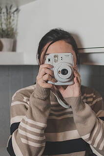 woman, taking, picture, using, instant camera, device, electronics, female, hands, Instax, leisure, manicured nails, modern, photographer, polaroid, snap, sweater, taking photo, taking picture, technology, wear, one person, photography themes, photographing, holding, camera - photographic equipment, front view, activity, real people, lifestyles, portrait, leisure activity, indoors, photographic equipment, casual clothing, young adult, focus on foreground, headshot, adult, digital camera, obscured face, 5K, CC0, public domain, royalty free
