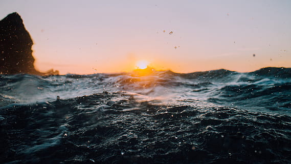 sea, ocean, water, wave, nature, sunshine, sunrise, sky, rocks, sunset, beauty in nature, scenics - nature, motion, sun, orange color, no people, splashing, waterfront, power in nature, outdoors, power, tranquility, horizon over water, flowing water, 4K, CC0, public domain, royalty free