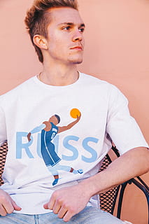 man facing sideways, casual clothing, front view, lifestyles, indoors, people, real people, young adult, young men, sitting, leisure activity, three quarter length, wall - building feature, adult, looking away, looking, men, portrait, t-shirt, contemplation, 5K, CC0, public domain, royalty free