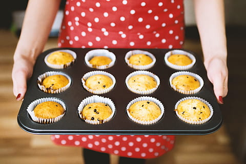young, lady, beautiful, red, apron, baked, muffins, one person, food, food and drink, midsection, holding, human hand, indoors, human body part, sweet food, hand, front view, adult, women, focus on foreground, close-up, freshness, sweet, polka dot, tray, 4K, CC0, public domain, royalty free