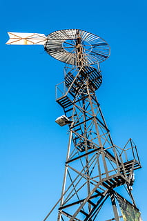 mill, wind, old, sky, energy, rural, agriculture, turn, metallic, structure, high, upload, blue, clear sky, low angle view, nature, day, no people, metal, outdoors, representation, architecture, built structure, animal, art and craft, tall - high, copy space, technology, animal themes, pattern, machinery, global communications, 5K, CC0, public domain, royalty free