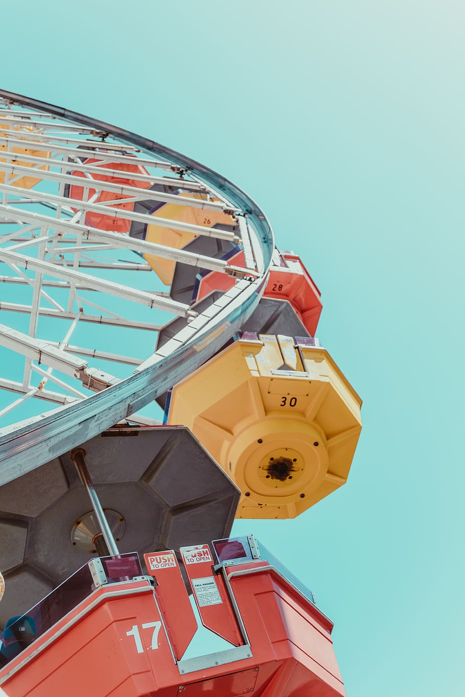 assorted-color ferriswheel, low angle view, sky, clear sky, built structure, amusement park ride, architecture, amusement park, no people, nature, blue, day, ferris wheel, building exterior, outdoors, arts culture and entertainment, yellow, tower, sunlight, metal, tilt, 5K