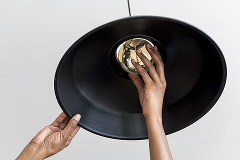 person, fixing, pendant lamp, ceiling, electric, electricity, fix, hands, indoors, installation, lamp, light, light bulb, human hand, hand, holding, human body part, one person, studio shot, close-up, white background, single object, directly above, adult, black color, high angle view, unrecognizable person, body part, shape, geometric shape, cut out, silver colored, 4K, CC0, public domain, royalty free