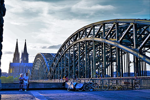 bridge, koln germany, architecture, built structure, transportation, real people, building exterior, men, connection, city, sky, group of people, bridge - man made structure, travel, travel destinations, incidental people, cloud - sky, mode of transportation, building, people, outdoors, 8K, CC0, public domain, royalty free