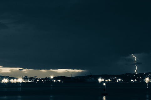 dark, storm, lightning, clouds, lights, thunder, cloud - sky, sky, illuminated, night, power in nature, nature, power, architecture, no people, building exterior, copy space, built structure, beauty in nature, thunderstorm, outdoors, city, water, light, 2K, CC0, public domain, royalty free