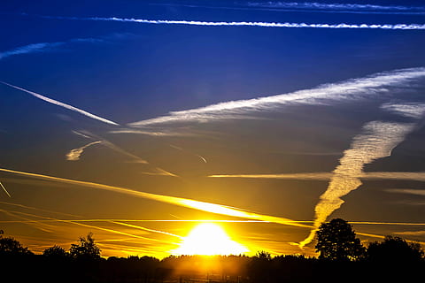 silhouette, trees, blue, yellow, skies, sunset, clouds, dawn, dramatic, forest, landscape, light, mood, morning sun, nature, rays, sky, sun, sunbeam, sunrise, weather, cloud - sky, beauty in nature, scenics - nature, tree, plant, tranquil scene, tranquility, sunlight, idyllic, no people, vapor trail, low angle view, outdoors, orange color, lens flare, 5K, CC0, public domain, royalty free