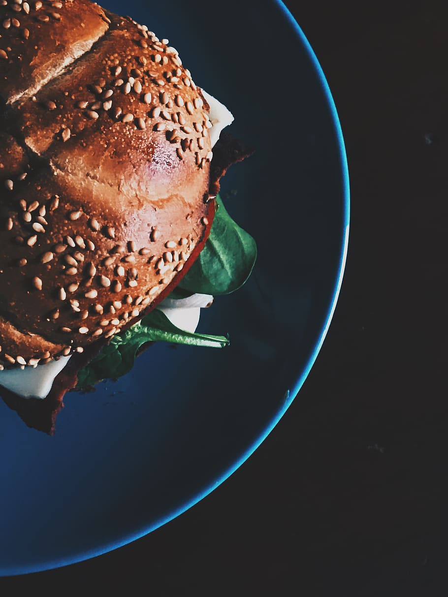 hamburguesa, blau, ceràmica, placa, pa, bun, primer pla, fosc, deliciós, epicure, menjar, fotografia de menjar, des de dalt, famolenc, entrepà, llavors de sèsam, espinacs, natura morta, saborós, torrat, pa de torrat, sandvitx de gall dindi, menjar i beguda, frescor, a l'interior, llest per menjar, cap gent, taula, vista d’angle alt, directament a sobre, menjar poc saludable, vegetals, benestar, esmorzar, fons negre, temptació, 4K