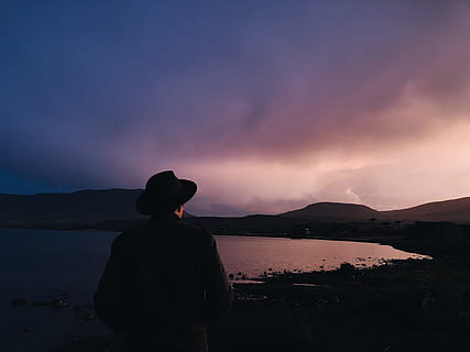 silhouette photography, person, sea, backlit, beach, clouds, dawn, nature, ocean, sky, sunrise, sunset, water, real people, mountain, one person, beauty in nature, silhouette, scenics - nature, leisure activity, cloud - sky, standing, lifestyles, rear view, tranquility, lake, tranquil scene, men, outdoors, 4K, CC0, public domain, royalty free