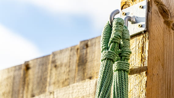 rope, string, binding, hook, the background, green color, strength, close-up, wall - building feature, day, no people, sky, nature, outdoors, wall, low angle view, selective focus, focus on foreground, built structure, copy space, architecture, surrounding wall, tied up, plant, wooden post, 5K, CC0, public domain, royalty free