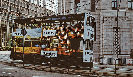 black double-deck bus, bus, transportation, vehicle, person, human, road, building, city, town, urban, metropolis, billboard, advertisement, pedestrian, street, kiosk, asphalt, tarmac, intersection, helmet, communication, architecture, text, building exterior, built structure, western script, sign, day, information, no people, non-western script, script, information sign, outdoors, graffiti, commercial sign, wall - building feature, 5K, CC0, public domain, royalty free