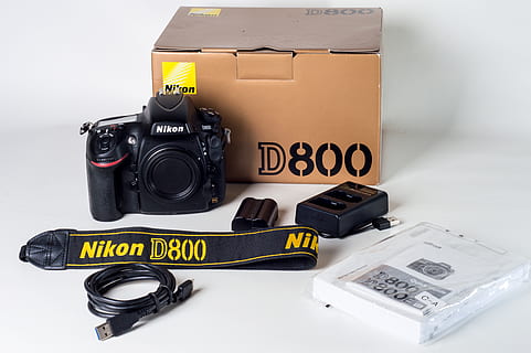 nikon d800 set, camera, camera strap, charger, d800, device, electronics, equipment, guide, manual, nikon, technology, camera - photographic equipment, photography themes, communication, text, photographic equipment, no people, indoors, still life, white background, close-up, studio shot, western script, table, black color, group of objects, occupation, large group of objects, digital camera, 5K, CC0, public domain, royalty free