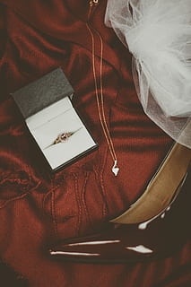ring, box, engagement ring, jewellery, jewelry, necklace, indoors, high angle view, still life, real people, one person, book, close-up, publication, textile, table, wood - material, paper, white color, furniture, celebration, pen, clothing, selective focus, personal accessory, 5K, CC0, public domain, royalty free