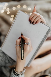 writing, notebook, lying, bed, coffee, candles, gingerbreads, female, girl, woman, workspace, work, hand, organizer, calendar, cosy, cozy, planning, human hand, one person, human body part, holding, real people, book, publication, women, indoors, selective focus, finger, adult, activity, paper, body part, human finger, high angle view, pen, nail, human limb, 5K
